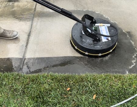 Image of a power washer in use cleaning a walkway